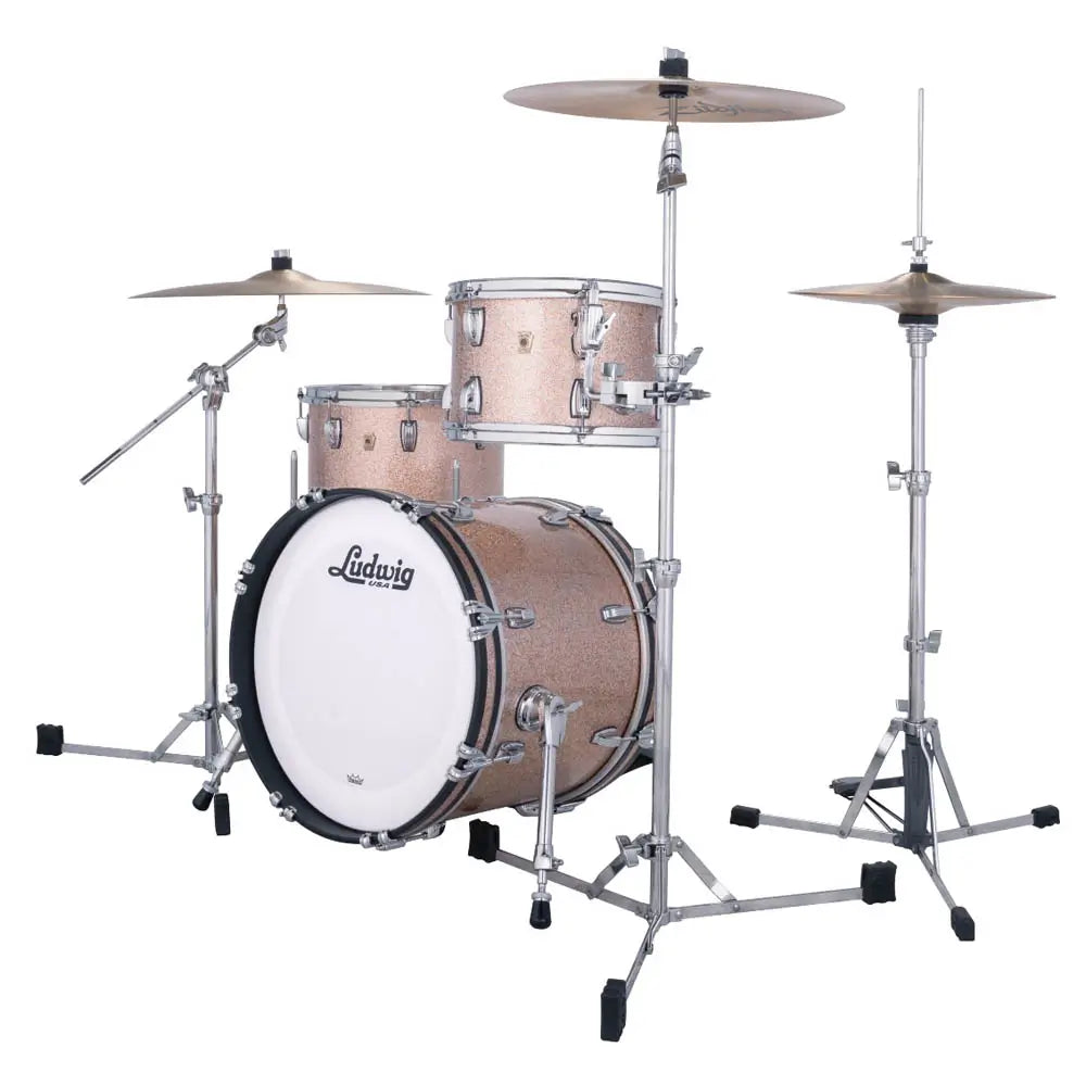 Ludwig drum kit with a shimmering rose gold finish, chrome hardware, a white front drum head, and two cymbals, shown on a solid white background.